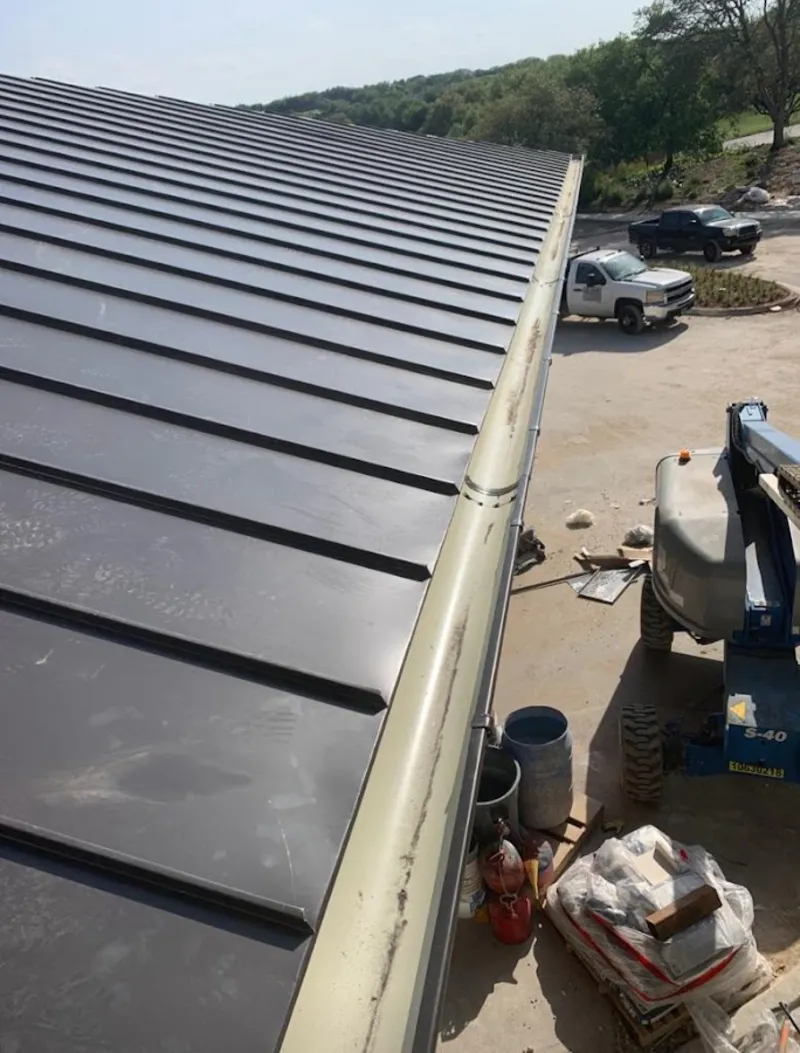 Standing seam panel and gutter detail on a metal roofing jobsite in Sullivan